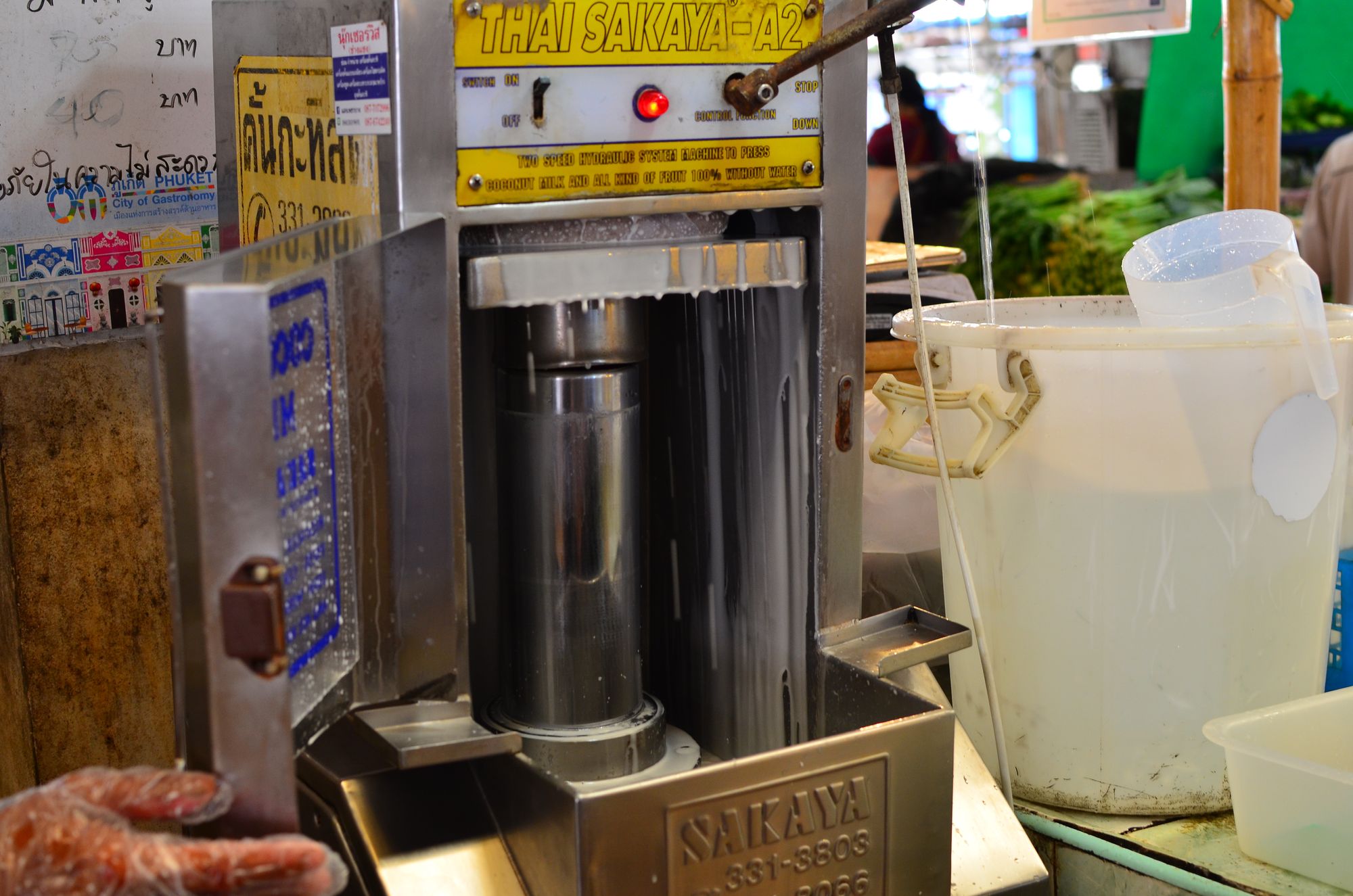 Preparing coconut milk at the market