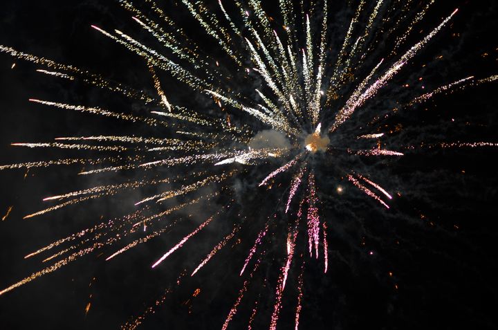 A firework explodes at midnight on New Year's Eve